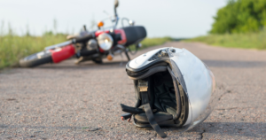 Motorcycle lying on the roadside after an accident in Hartford, with a helmet in the foreground