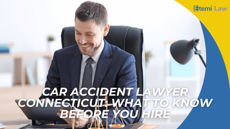 Attorney in suit using tablet at desk with scales of justice introducing hiring a car accident lawyer