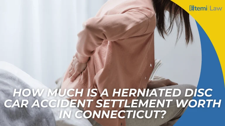 Person holding lower back in pain highlights herniated disc injury and settlement value in Connecticut